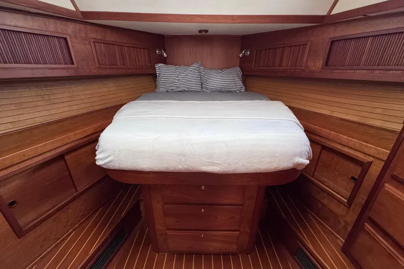 Slide: The Image of Luxurious wooden cabin interior of 2004 Sabre 42 Fly Bridge yacht with cozy bed. - 25
