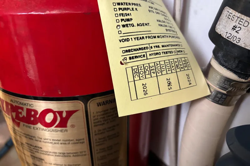 Slide: The Image of Fire extinguisher with service tag, aboard 2004 Sabre 42 Fly Bridge yacht. - 29