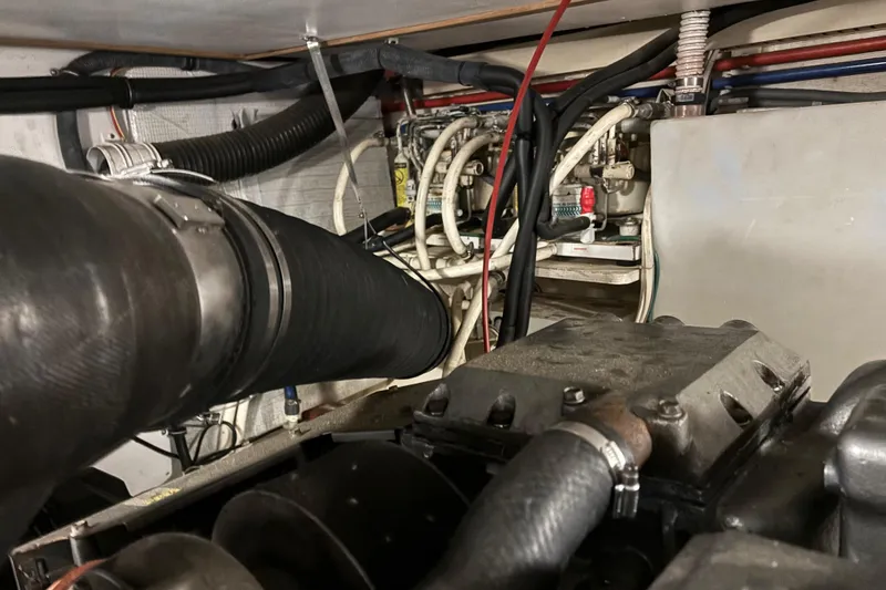 Slide: The Image of Engine room of a 2004 Sabre 42 Fly Bridge with visible hoses and components. - 30