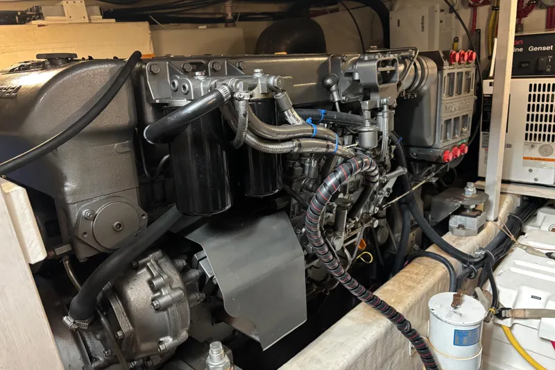 Slide: The Image of Engine room of a 2004 Sabre 42 Fly Bridge, showcasing detailed mechanical components. - 31