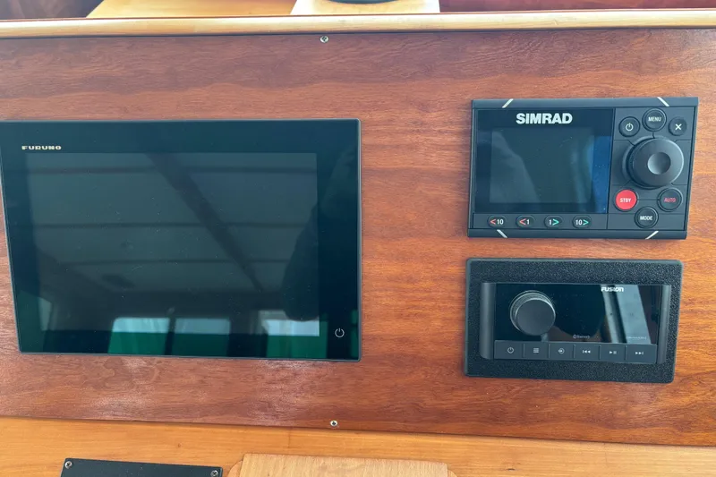 Slide: The Image of Control panel of a 2004 Sabre 42 Fly Bridge with Furuno and Simrad displays. - 38