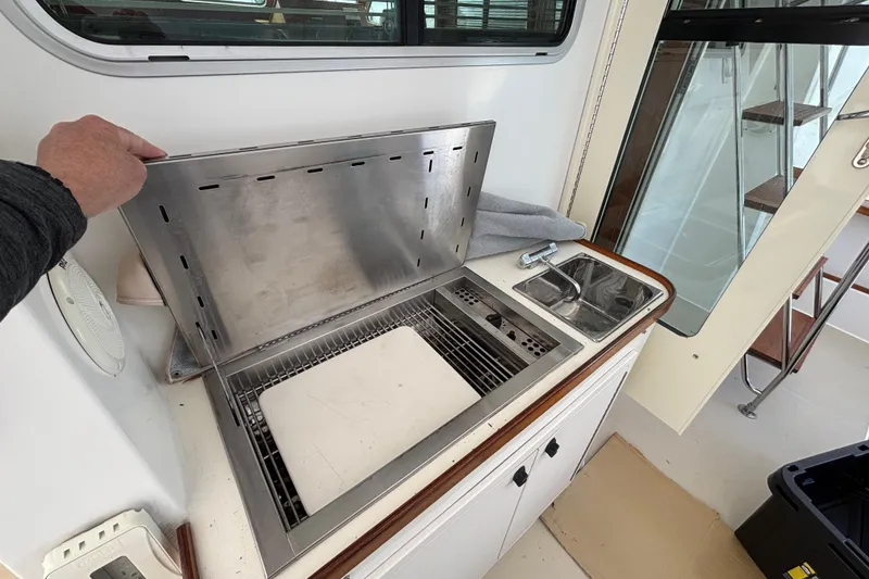 Slide: The Image of Outdoor kitchen area on a 2004 Sabre 42 Fly Bridge yacht with grill and sink. - 39