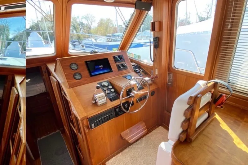Slide: The Image of 2004 Sabre 42 Fly Bridge helm with wooden interior and navigation equipment. - 7