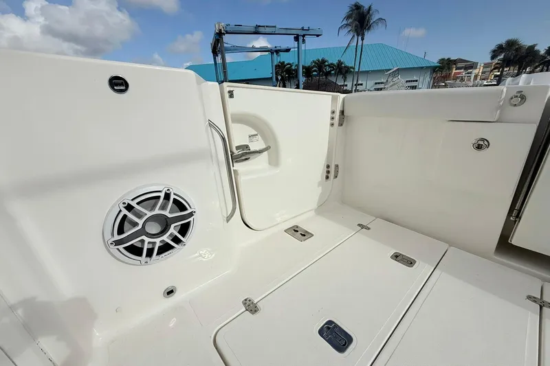 Slide: The Image of 2022 Pursuit DC 365 Dual Console boat interior with speaker and storage compartments. - 10