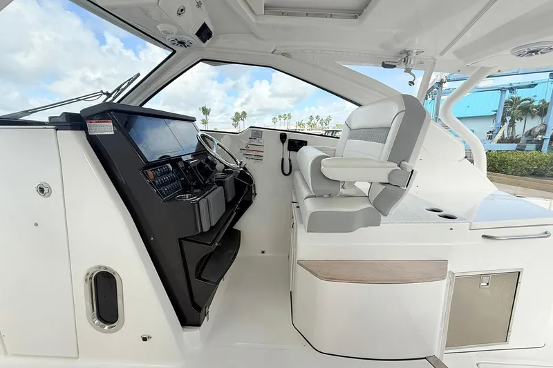 Slide: The Image of 2022 Pursuit DC 365 Dual Console interior with helm and seating, showcasing modern design. - 13