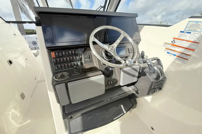 Slide: The Image of Helm of 2022 Pursuit DC 365 Dual Console with steering wheel and control panel. - 15