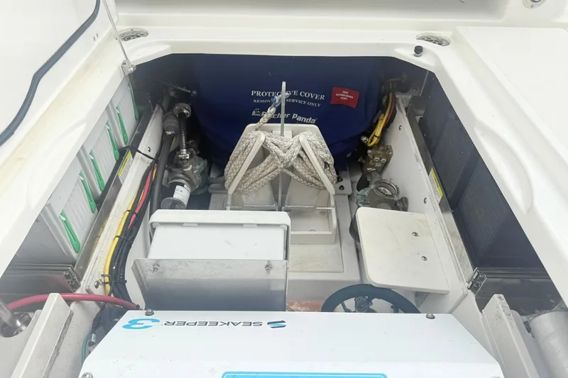 Slide: The Image of Engine compartment of a 2022 Pursuit DC 365 Dual Console boat, featuring various components. - 24