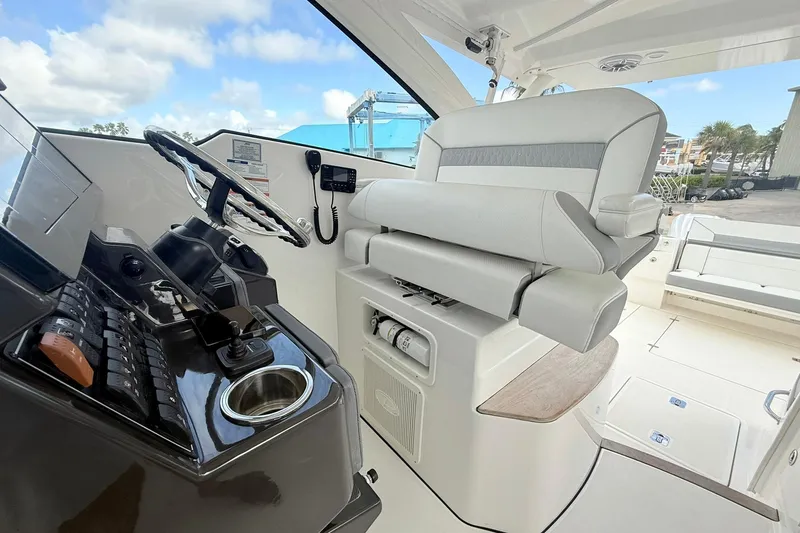 Slide: The Image of 2022 Pursuit DC 365 Dual Console boat interior with steering wheel and seating. - 3
