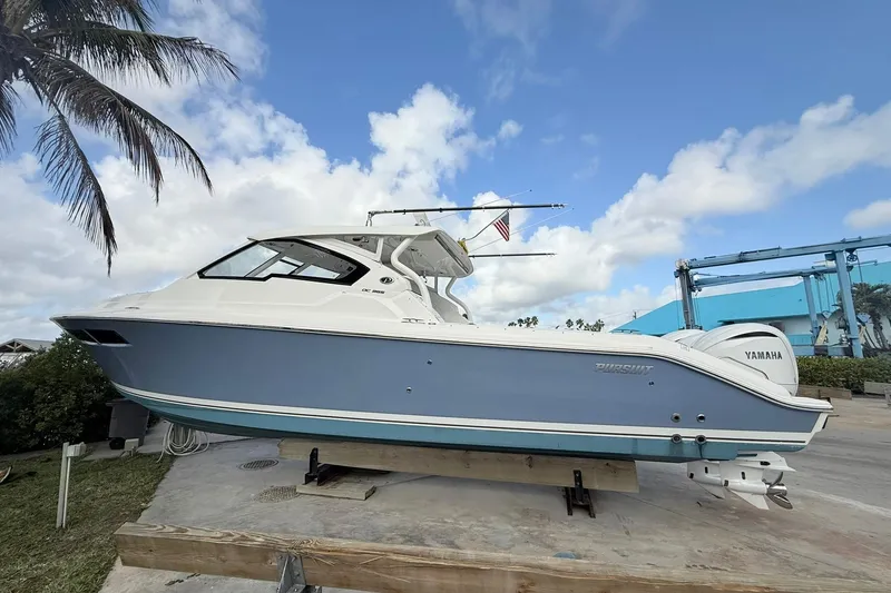 Slide: The Image of 2022 Pursuit DC 365 Dual Console boat on display, featuring Yamaha engines. - 5