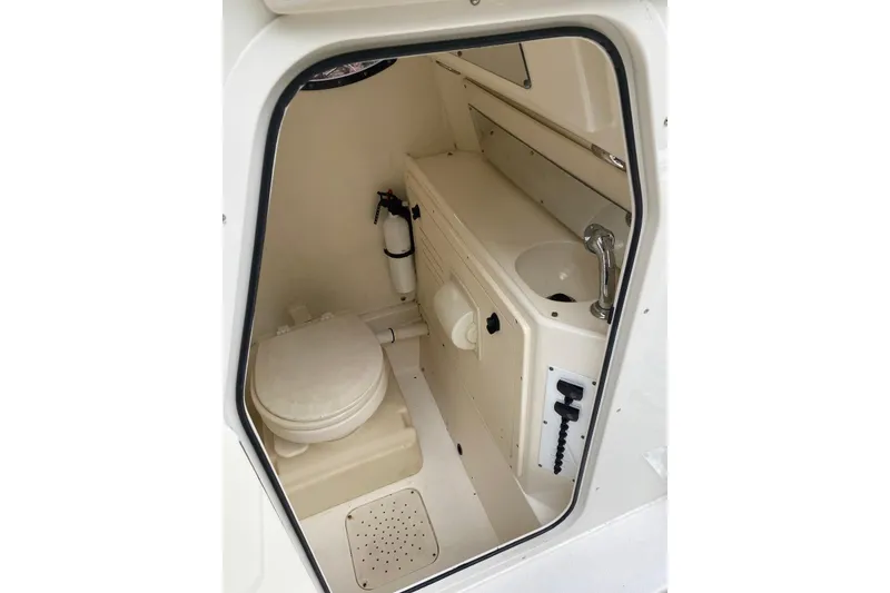 Slide: The Image of Compact marine bathroom in a 2013 Blackwood 27 boat, featuring a toilet and sink. - 10
