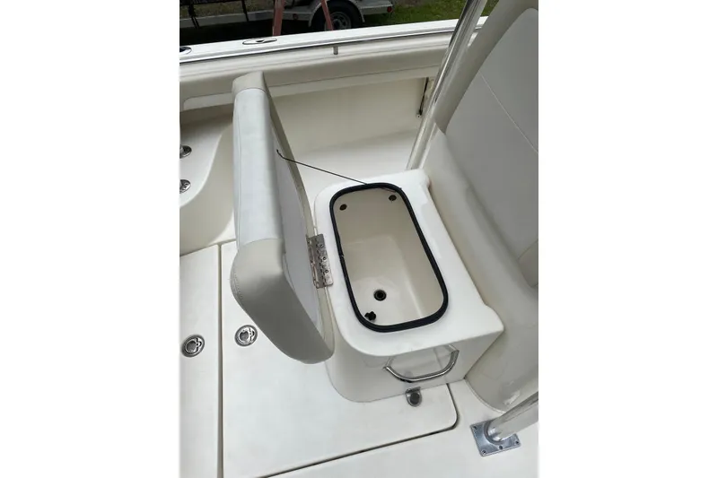 Slide: The Image of 2013 Blackwood 27 boat seat with built-in storage compartment open. - 11