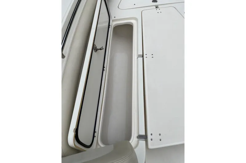 Slide: The Image of Open storage compartment on a 2013 Blackwood 27 boat, showcasing interior space. - 12