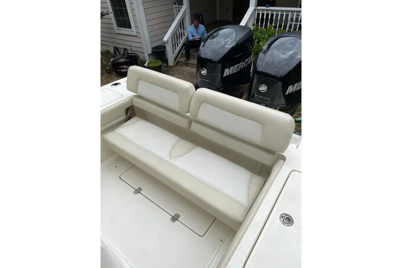 Slide: The Image of 2013 Blackwood 27 boat with beige seating and dual Mercury outboard engines. - 6