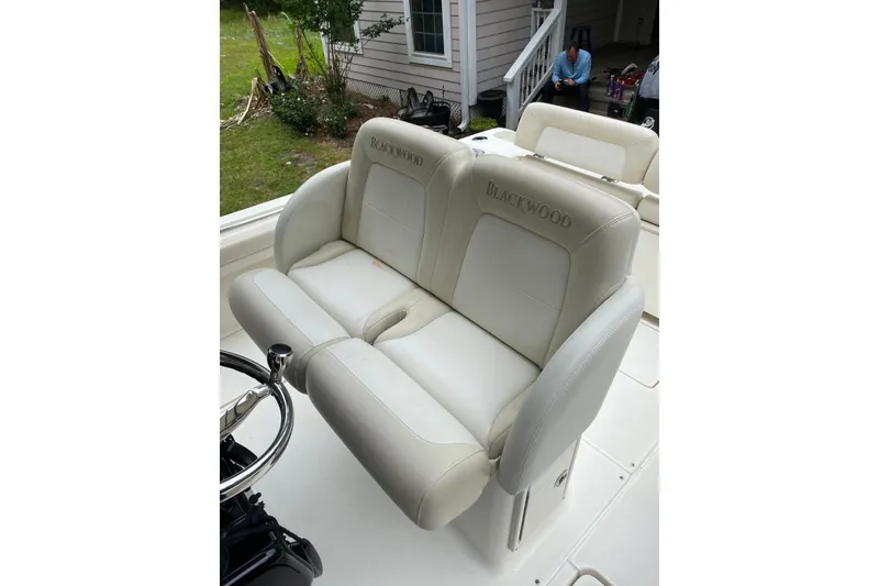 Slide: The Image of Luxurious seating on a 2013 Blackwood 27 boat, featuring plush white upholstery. - 7