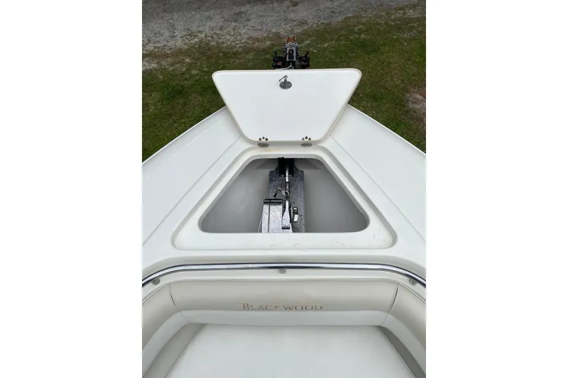 Slide: The Image of Open anchor compartment on a 2013 Blackwood 27 boat, showcasing storage space. - 9