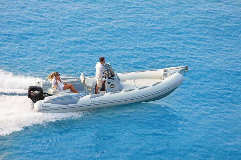 The Image of 2026 Ranieri Cayman 21.0 Sport boat cruising on clear blue water. - 0