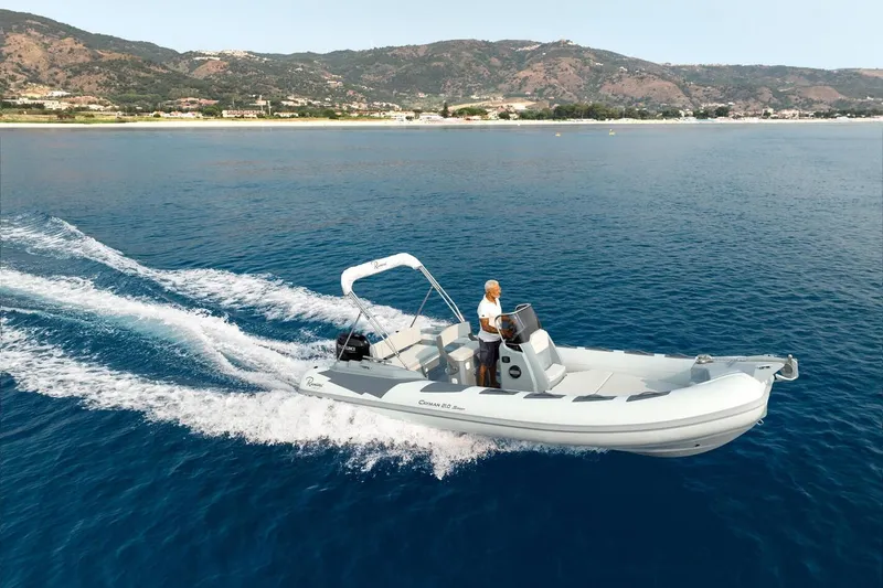 Slide: The Image of 2026 Ranieri Cayman 21.0 Sport cruising on blue ocean near scenic coastline. - 3