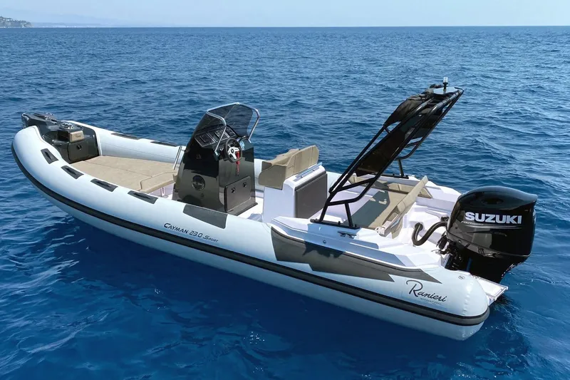 Slide: The Image of 2026 Ranieri Cayman 23.0 Sport boat on open sea with Suzuki outboard motor. - 1