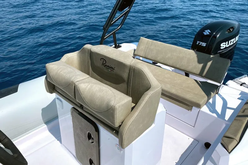 Slide: The Image of 2026 Ranieri Cayman 23.0 Sport boat interior with Suzuki engine on blue ocean. - 6