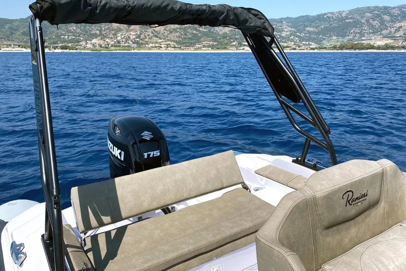 Slide: The Image of 2026 Ranieri Cayman 23.0 Sport boat on blue ocean with Suzuki 175 engine. - 7