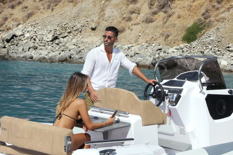 Slide: The Image of Couple enjoying a 2026 Ranieri Cayman 23.0 Sport Touring boat on a sunny day. - 4