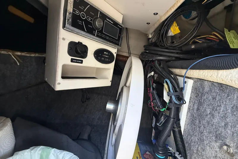 Slide: The Image of Interior view of a 2014 Sea Ray 220 Sundeck showing control panel and wiring. - 19