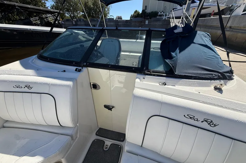 Slide: The Image of 2014 Sea Ray 220 Sundeck boat interior with white seating and windshield. - 5