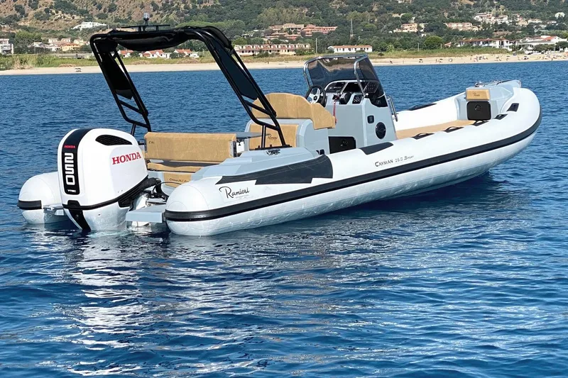 The Image of 2026 Ranieri Cayman 26.0 Sport boat on blue water with Honda engine. - 0