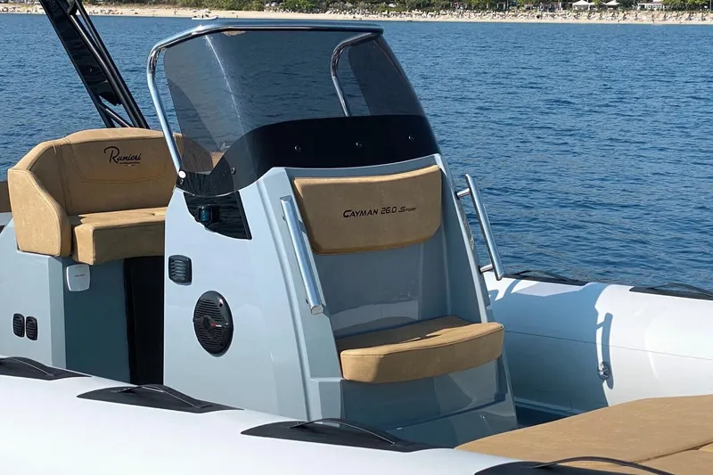 Slide: The Image of 2026 Ranieri Cayman 26.0 Sport boat on water, featuring sleek design and comfortable seating. - 10