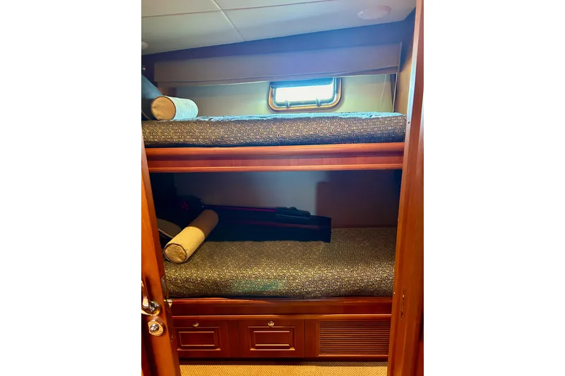 Slide: The Image of Bunk beds in 2012 Grand Banks 53 Aleutian RP yacht cabin with wooden finish. - 14