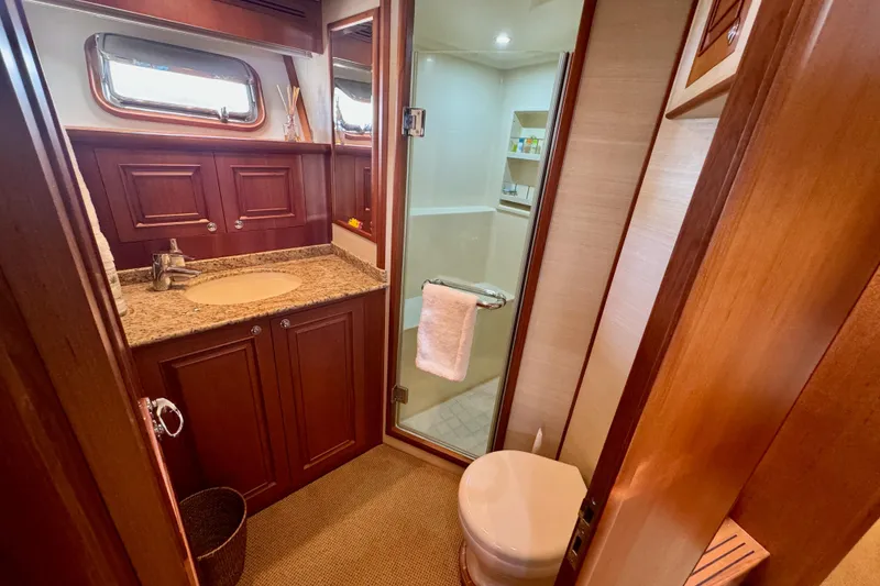 Slide: The Image of Luxurious bathroom on 2012 Grand Banks 53 Aleutian RP yacht with wood cabinetry and granite countertop. - 15