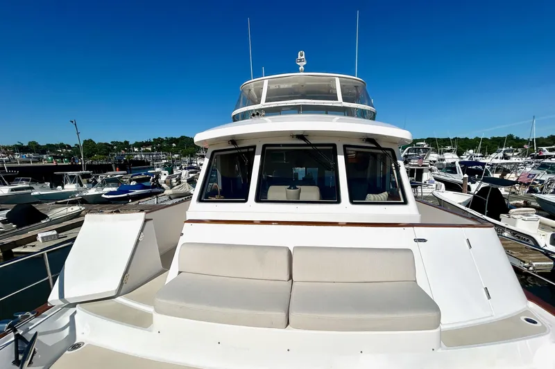 Slide: The Image of 2012 Grand Banks 53 Aleutian RP yacht docked at marina under clear blue sky. - 17