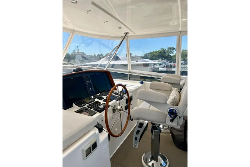 Slide: The Image of Helm of 2012 Grand Banks 53 Aleutian RP yacht with steering wheel and navigation controls. - 21