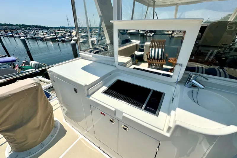 Slide: The Image of Outdoor kitchen on 2012 Grand Banks 53 Aleutian RP yacht, featuring grill and sink. - 23