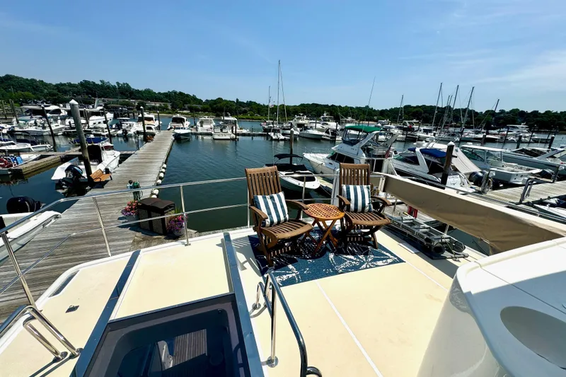 Slide: The Image of 2012 Grand Banks 53 Aleutian RP yacht docked at marina with seating area. - 24