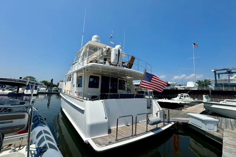 Slide: The Image of 2012 Grand Banks 53 Aleutian RP yacht docked at marina under clear blue sky. - 28
