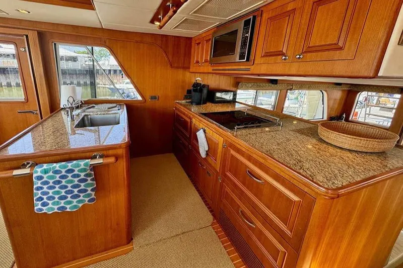 Slide: The Image of Luxurious kitchen interior of 2012 Grand Banks 53 Aleutian RP yacht with wooden cabinetry. - 6