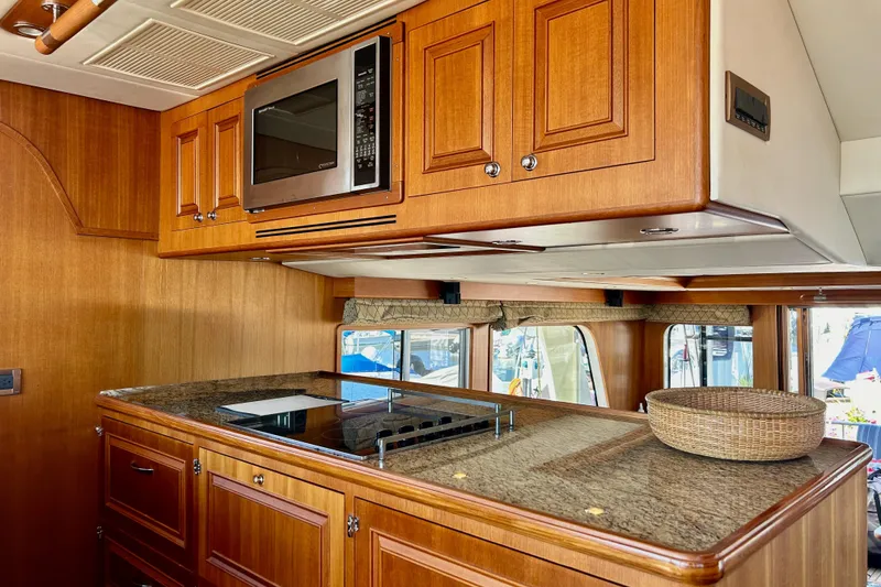 Slide: The Image of Luxurious kitchen interior of 2012 Grand Banks 53 Aleutian RP yacht with wooden cabinetry. - 7
