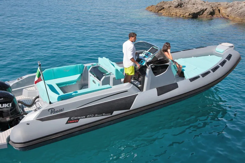 The Image of 2026 Ranieri CAYMAN 27.0 SPORT TOURING boat on clear blue water, featuring sleek design. - 0