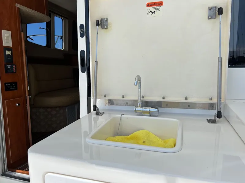 Slide: The Image of Storage compartment on 2007 Silverton 36 Convertible with cleaning supplies. - 10