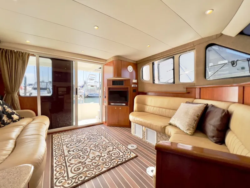 Slide: The Image of Interior of 2007 Silverton 36 Convertible with leather sofas and wooden table. - 15