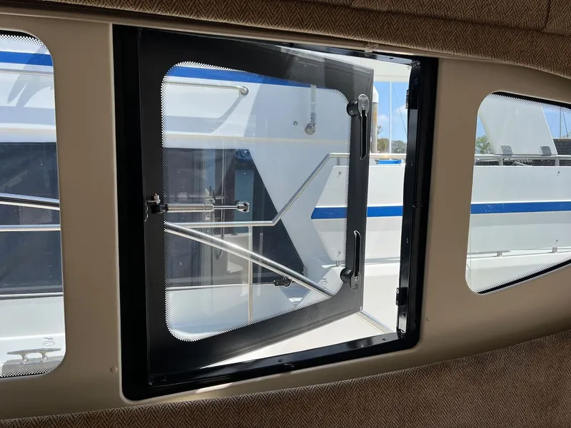 Slide: The Image of Interior of 2007 Silverton 36 Convertible with leather sofa and wooden table. - 16