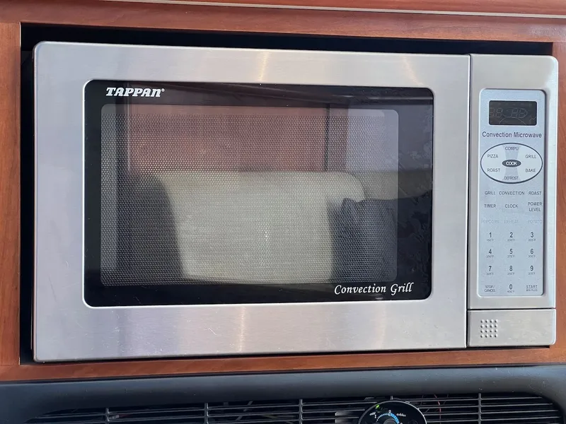 Slide: The Image of Interior of 2007 Silverton 36 Convertible with leather sofas and wooden table. - 19