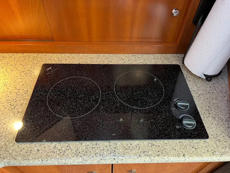 Slide: The Image of Interior of 2007 Silverton 36 Convertible with wooden table and cushioned sofa. - 20