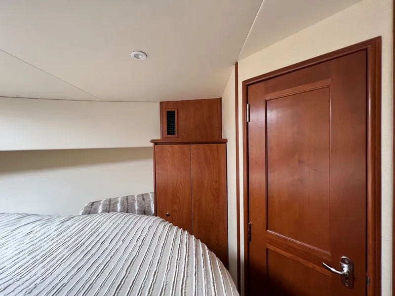 Slide: The Image of Interior of 2007 Silverton 36 Convertible with kitchen and wood cabinetry. - 25