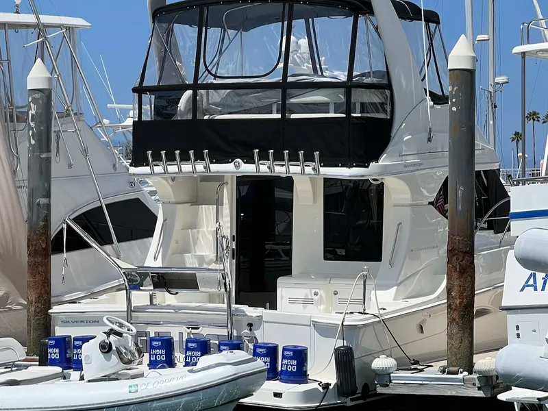 Slide: The Image of 2007 Silverton 36 Convertible yacht docked, featuring luxurious design. - 3