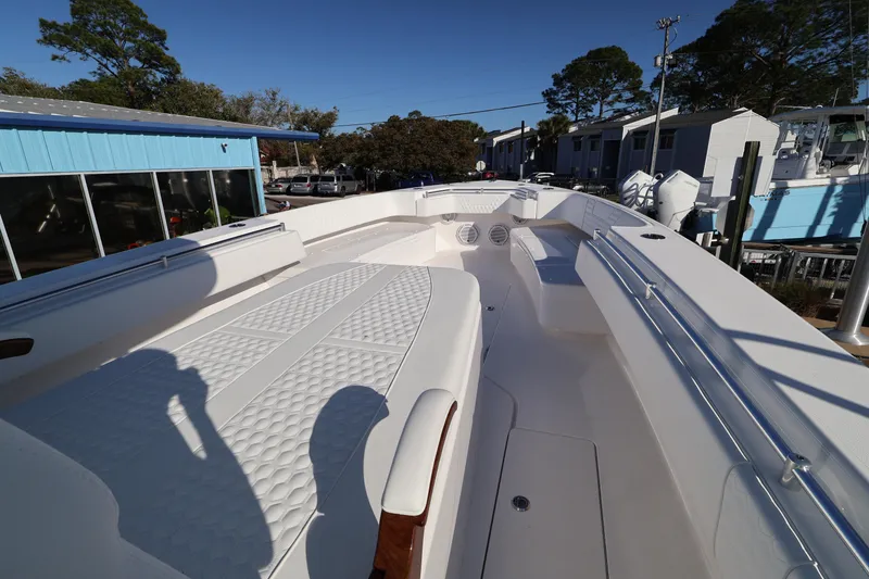 Slide: The Image of Helm of 2026 Contender 44 CB boat with advanced navigation display and controls. - 12