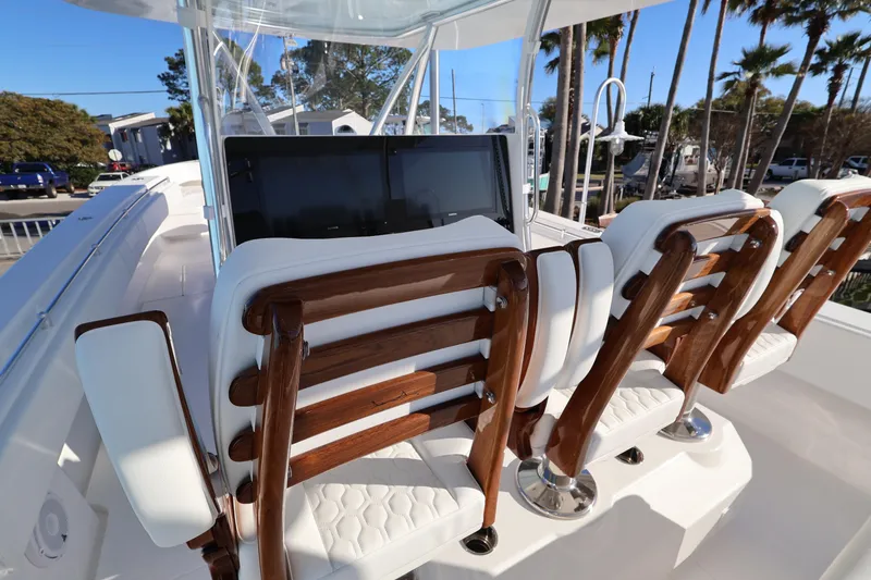 Slide: The Image of Helm controls of 2026 Contender 44 CB boat with steering wheel and throttle. - 14