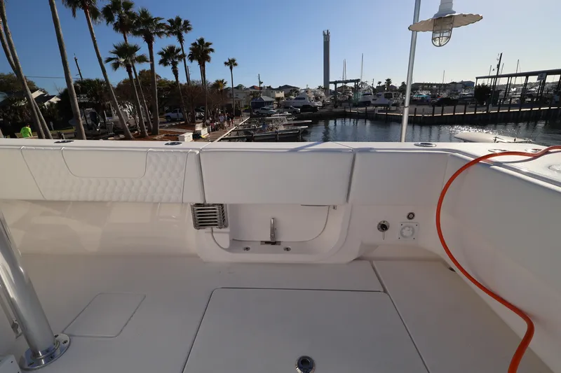 Slide: The Image of Joystick control on 2026 Contender 44 CB boat dashboard with warning label. - 17