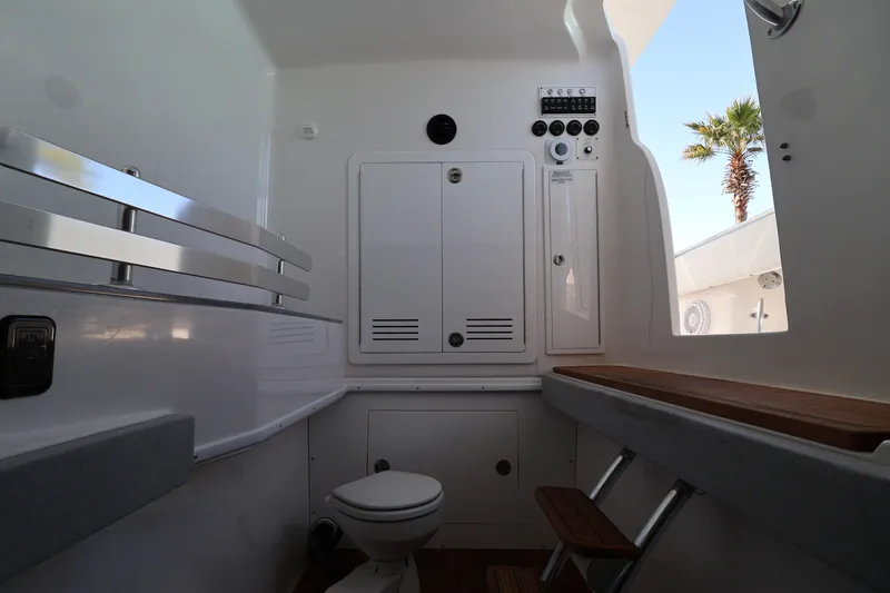 Slide: The Image of Luxury seating on 2026 Contender 44 CB boat with polished wood and white cushions. - 22